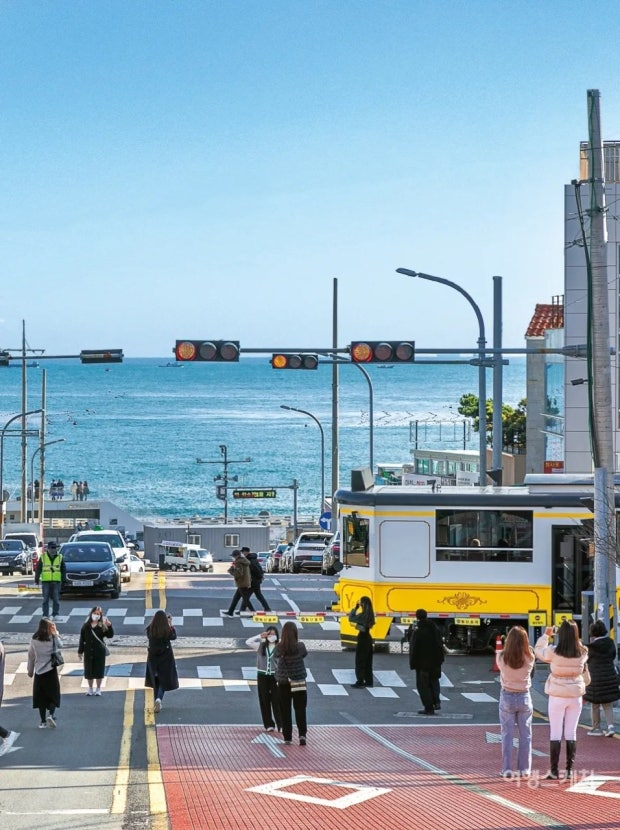 Yellow Beach Train and visitors at the Cheongsapo railway crossing