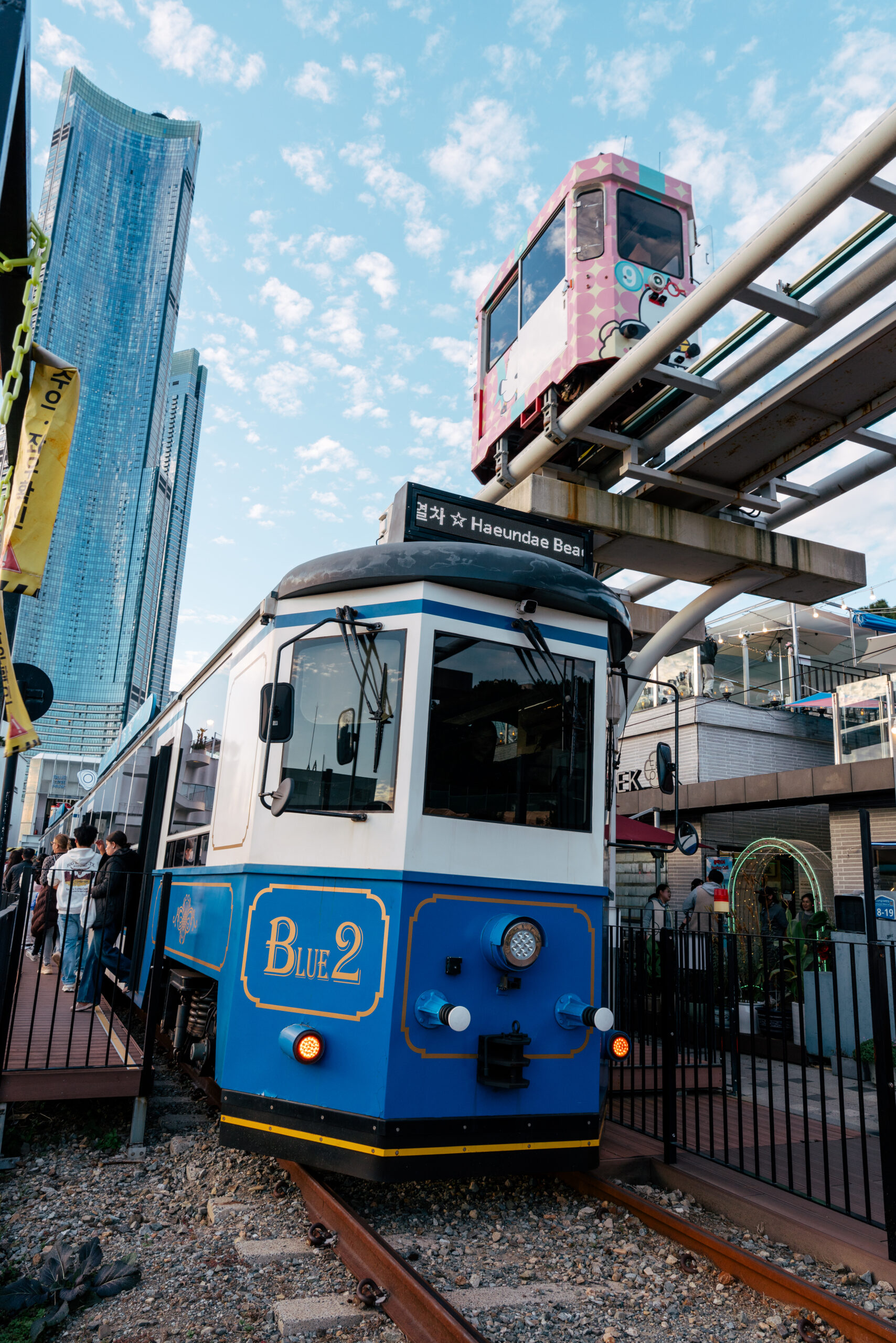 Beach Train beneath the elevated Sky Capsule at Haeundae Blueline Park