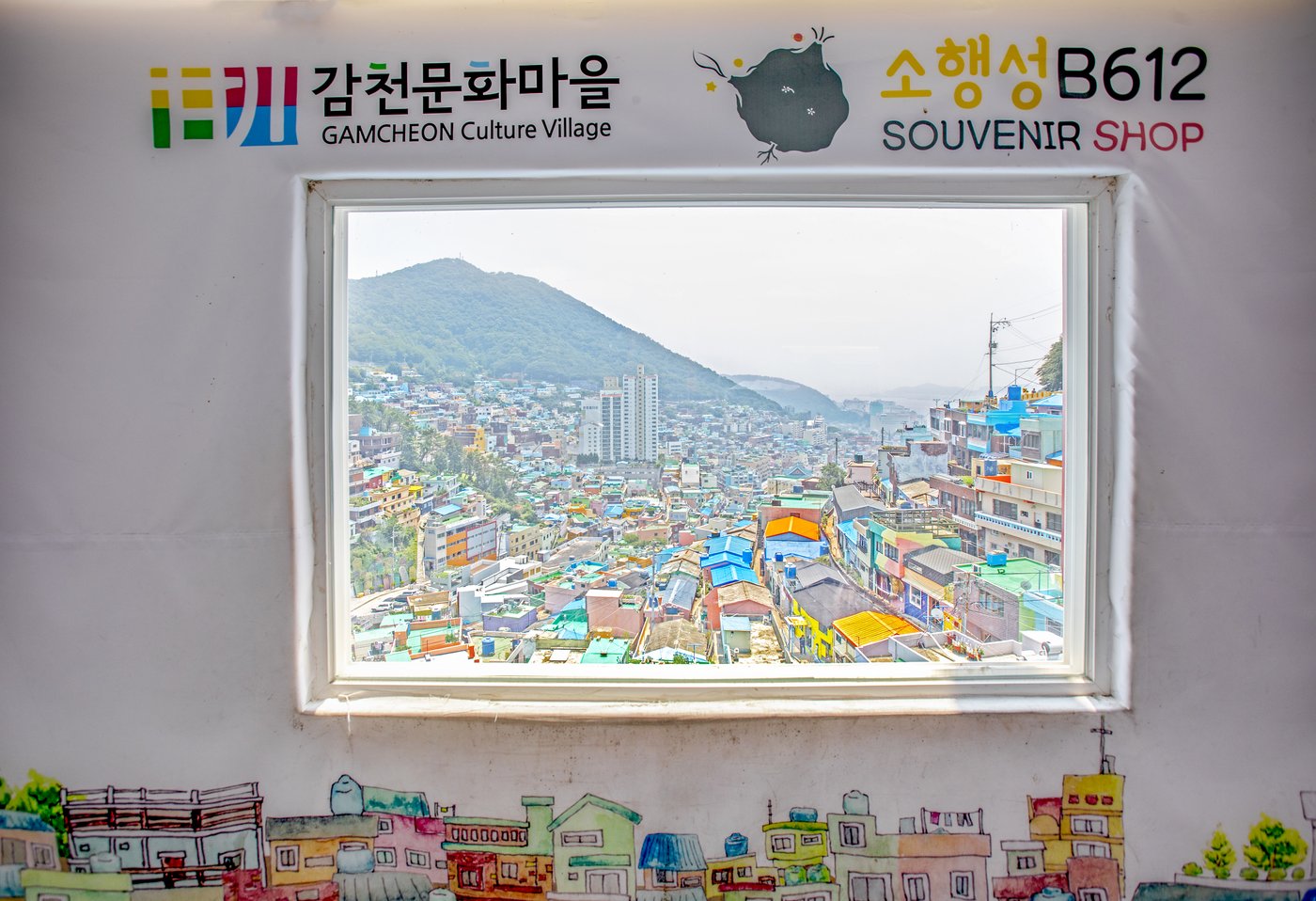 A window marked B612 Souvenir Shop frames the colourful Gamcheon hillside.
