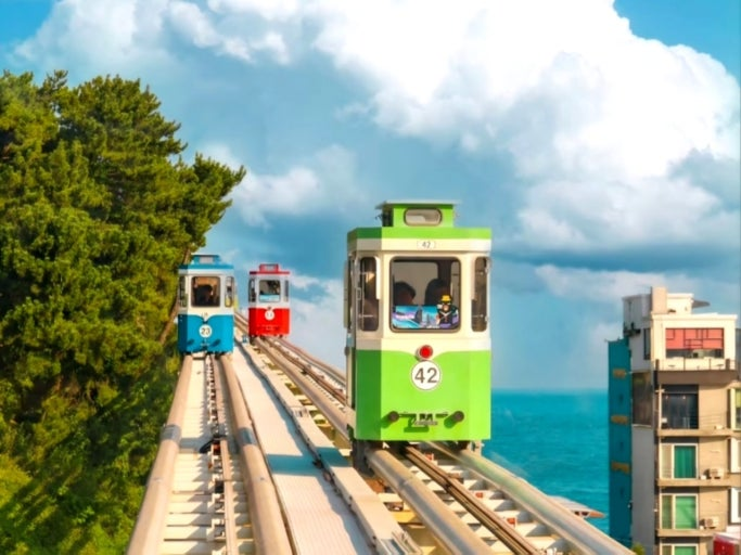 Green Sky Capsule travelling along the elevated coastal track