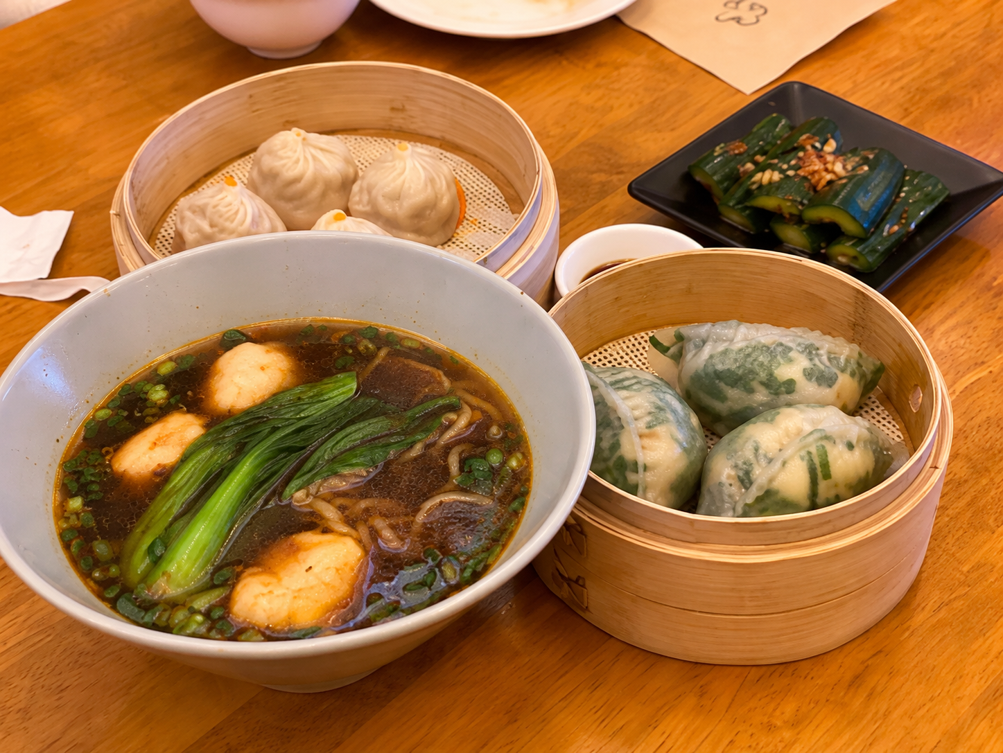Noodle soup and bamboo baskets of dim sum at Dim Tao — AI-assisted edit