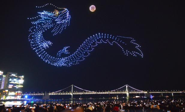 Blue dragon-shaped drones above Gwangalli Beach and Gwangan Bridge at a previous show