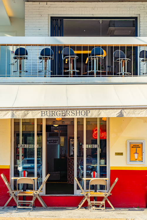 Red and cream burger shop storefront with a balcony in Haeridan-gil