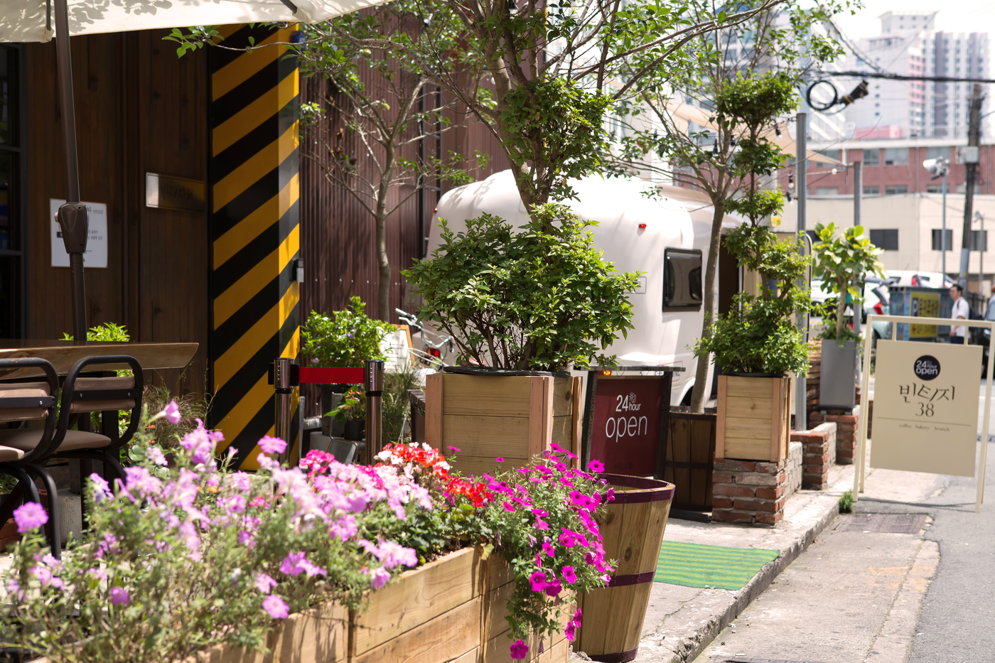 Plants and flower boxes outside a cafe on a Jeonpo side street