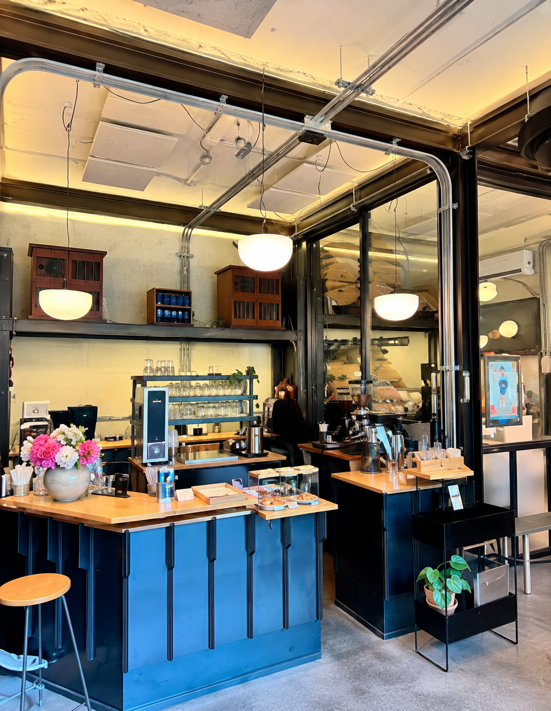 Blue coffee counter and pendant lights at Strut Coffee — AI-assisted edit