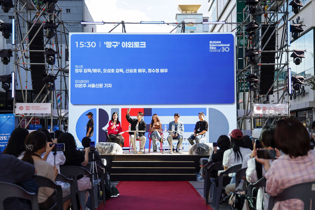 Audience facing the outdoor talk stage at Community BIFF in 2025