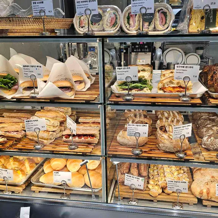 Sandwiches and fresh bread in the display at Ordinary Recipe in Centum City