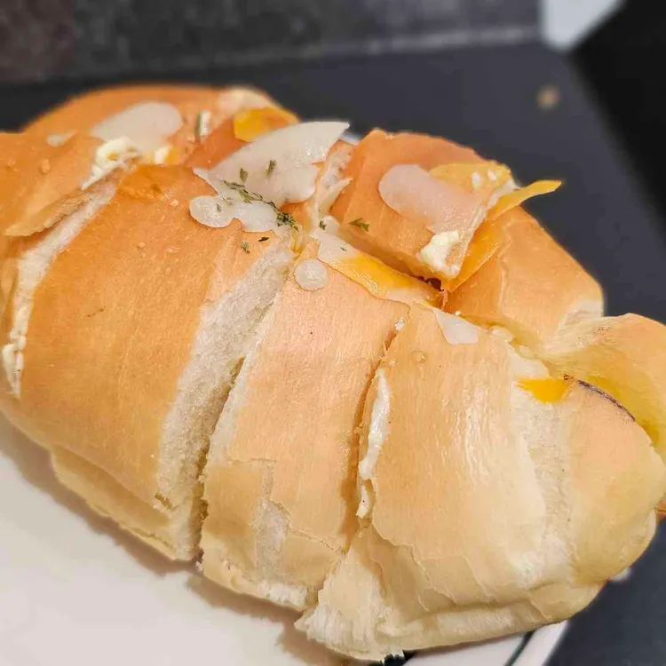 A sliced bread roll with creamy filling at Ordinary Recipe