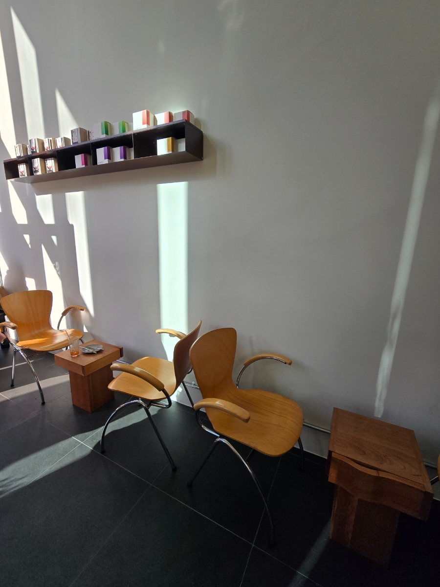 Wooden chairs and window light inside PAR Coffee Office in Centum