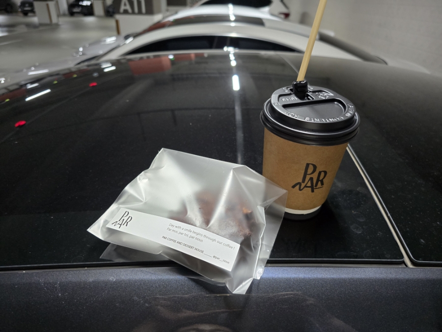 PAR-branded takeaway coffee and a wrapped cookie from PAR Coffee Office