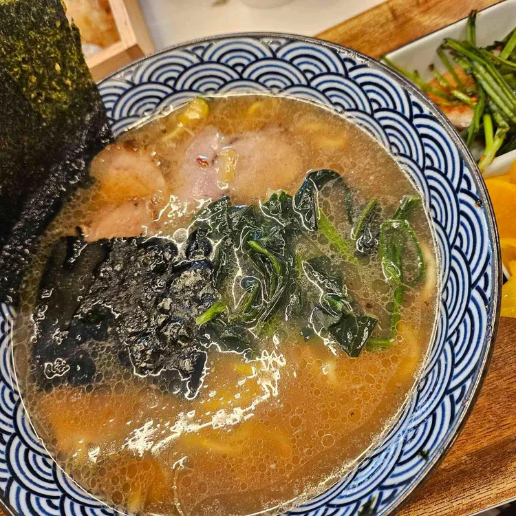 A bowl of ramen with pork, greens and seaweed at Sangsaeng Ramen